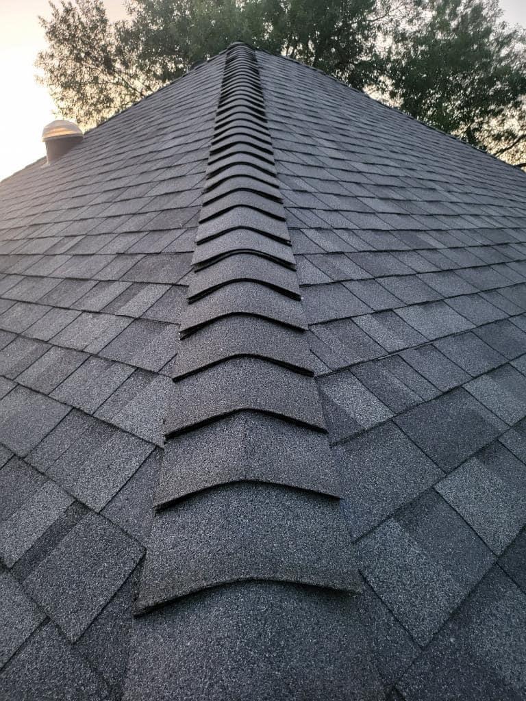 Close-up of newly installed roof ridge cap shingles