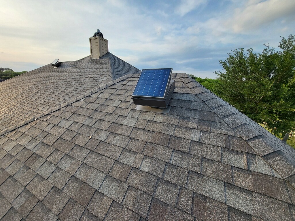 Solar attic vent installed on shingle roof