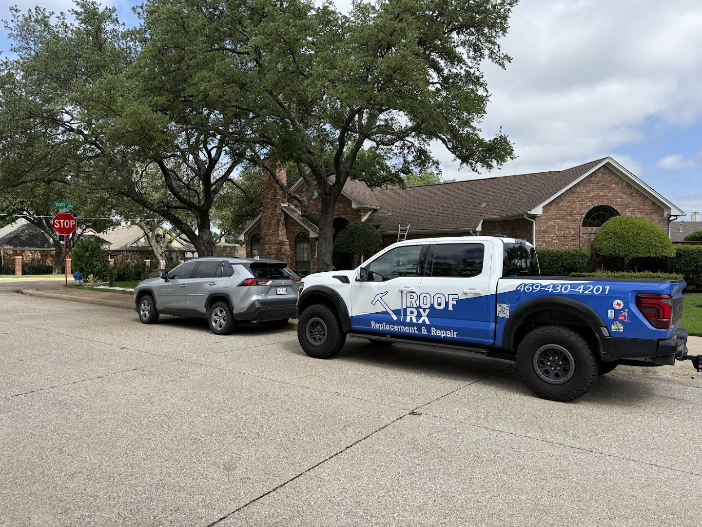 Company branded truck parked in front of house
